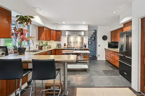 a kitchen with a table chairs and a refrigerator