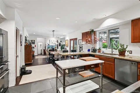 a kitchen with granite countertop stainless steel appliances and wooden cabinets