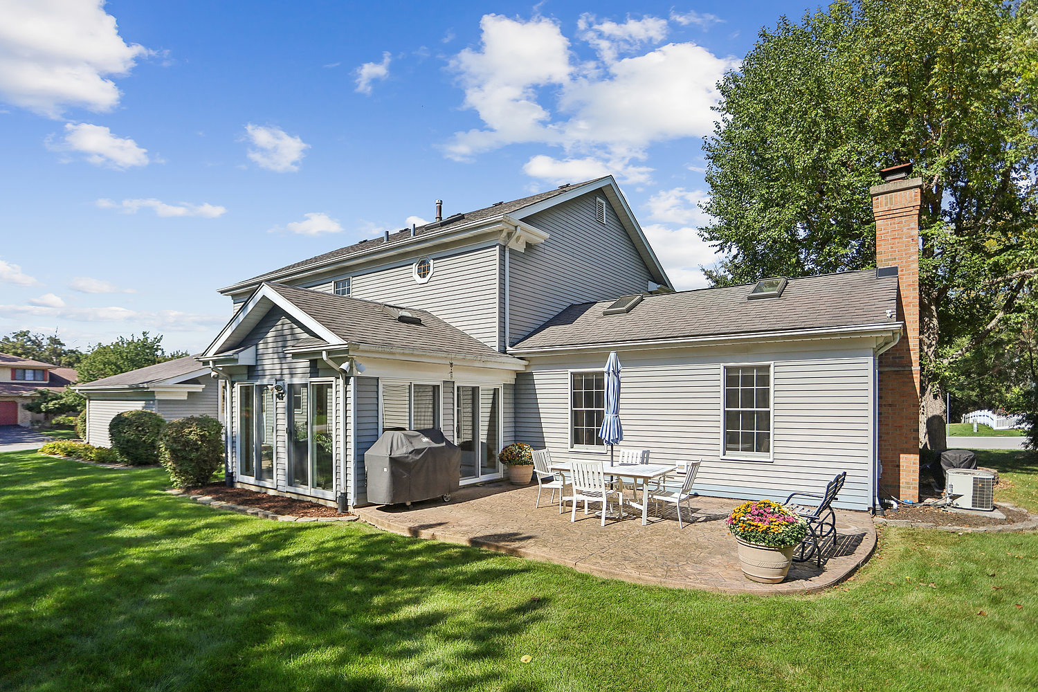 580 Moray Terrace Crete, IL 60417 - Photo 29 of 35 a view of a patio with table and chairs potted plants and a large tree