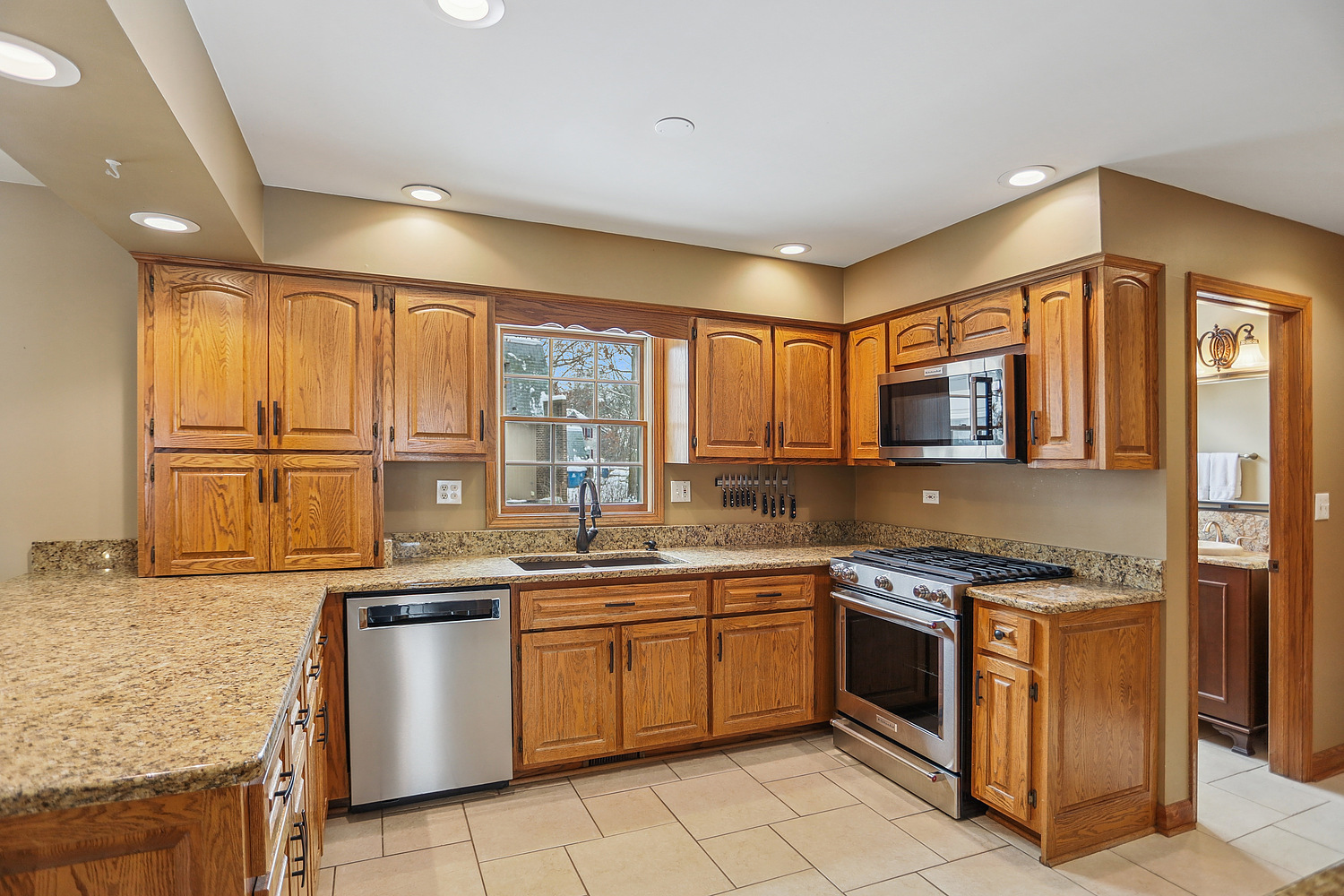 580 Moray Terrace Crete, IL 60417 - Photo 9 of 35 a kitchen with stainless steel appliances granite countertop a stove sink and cabinets