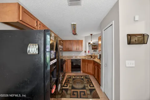 a kitchen with stainless steel appliances granite countertop a stove and a refrigerator