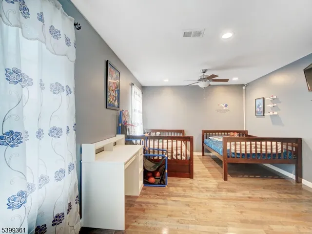 a view of a bedroom with furniture and wooden floor