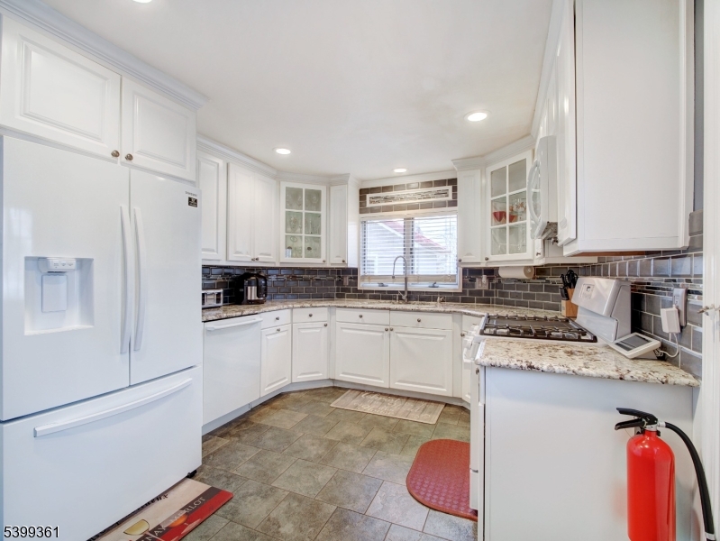 2 Papakating Road Hopatcong, NJ 07843 - Photo 2 of 28 a kitchen with stainless steel appliances granite countertop a refrigerator sink and cabinets