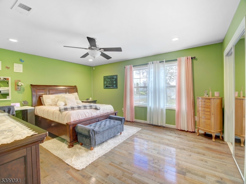 2 Papakating Road Hopatcong, NJ 07843 - Photo 22 of 28 a spacious bedroom with a large bed and a chandelier
