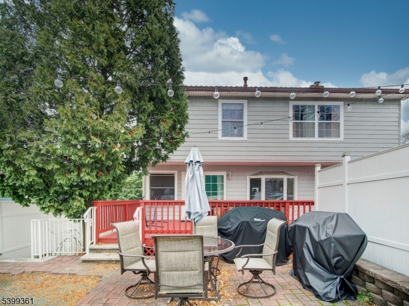 2 Papakating Road Hopatcong, NJ 07843 - Photo 28 of 28 a view of a patio with table and chairs with wooden floor and fence
