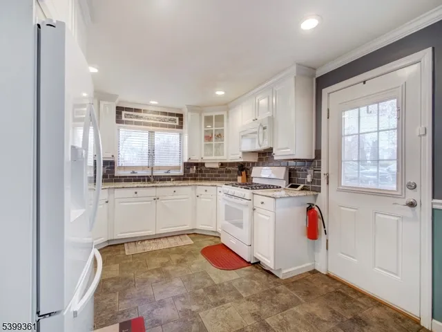 a kitchen with granite countertop a sink cabinets and window