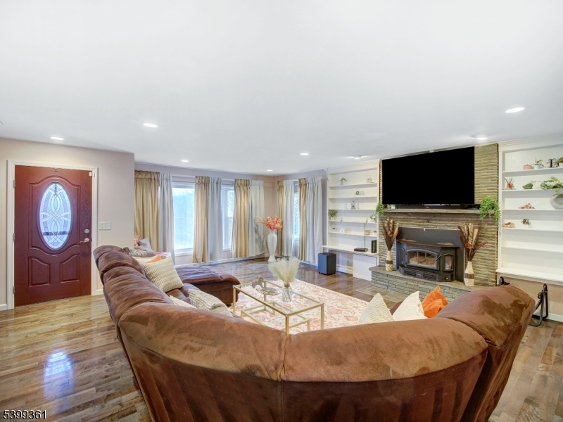 2 Papakating Road Hopatcong, NJ 07843 - Photo 6 of 28 a living room with fireplace furniture and a flat screen tv