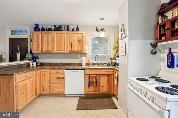 a kitchen with a stove a sink and a refrigerator