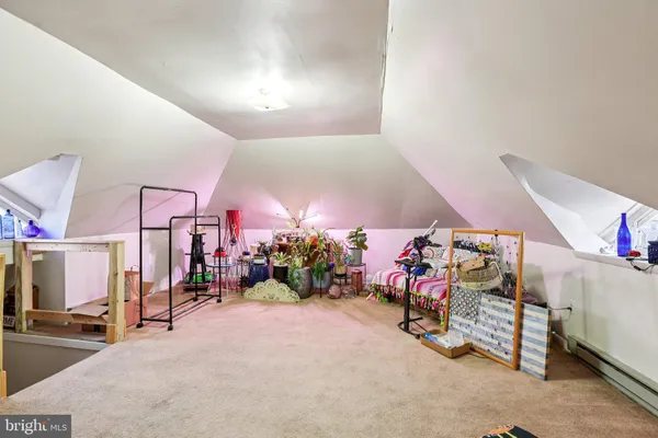 a living room with furniture a window and a flat screen tv
