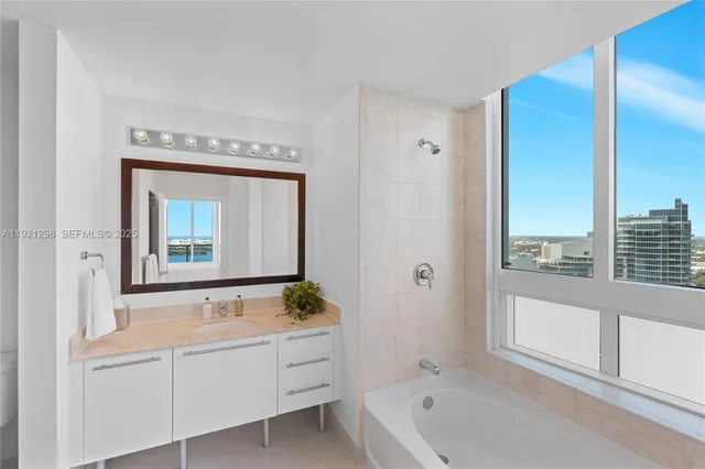 a living room with furniture a rug and a large window