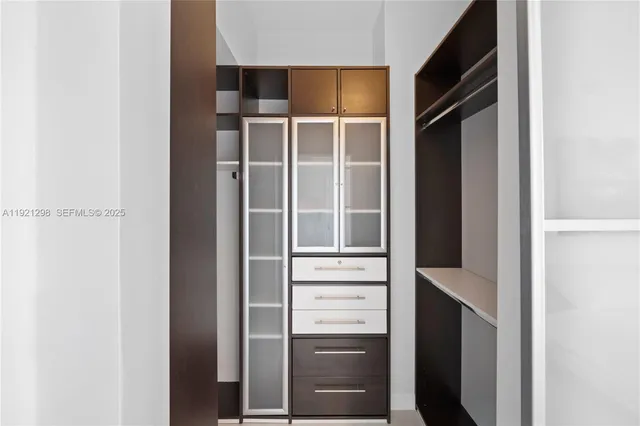 a view of walk in closet with empty racks
