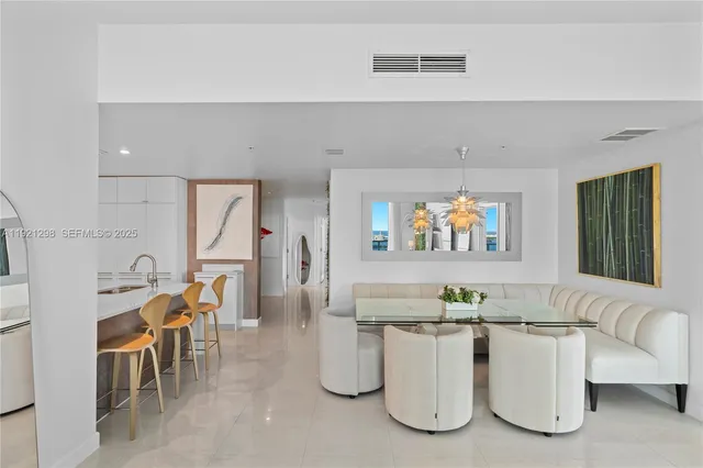 a bathroom with a tub a sink and a large mirror