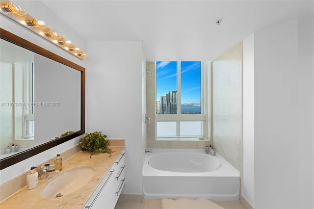 a bed room with a bed and a flat screen tv