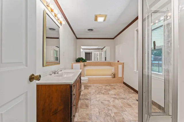 a bathroom with a sink toilet and mirror