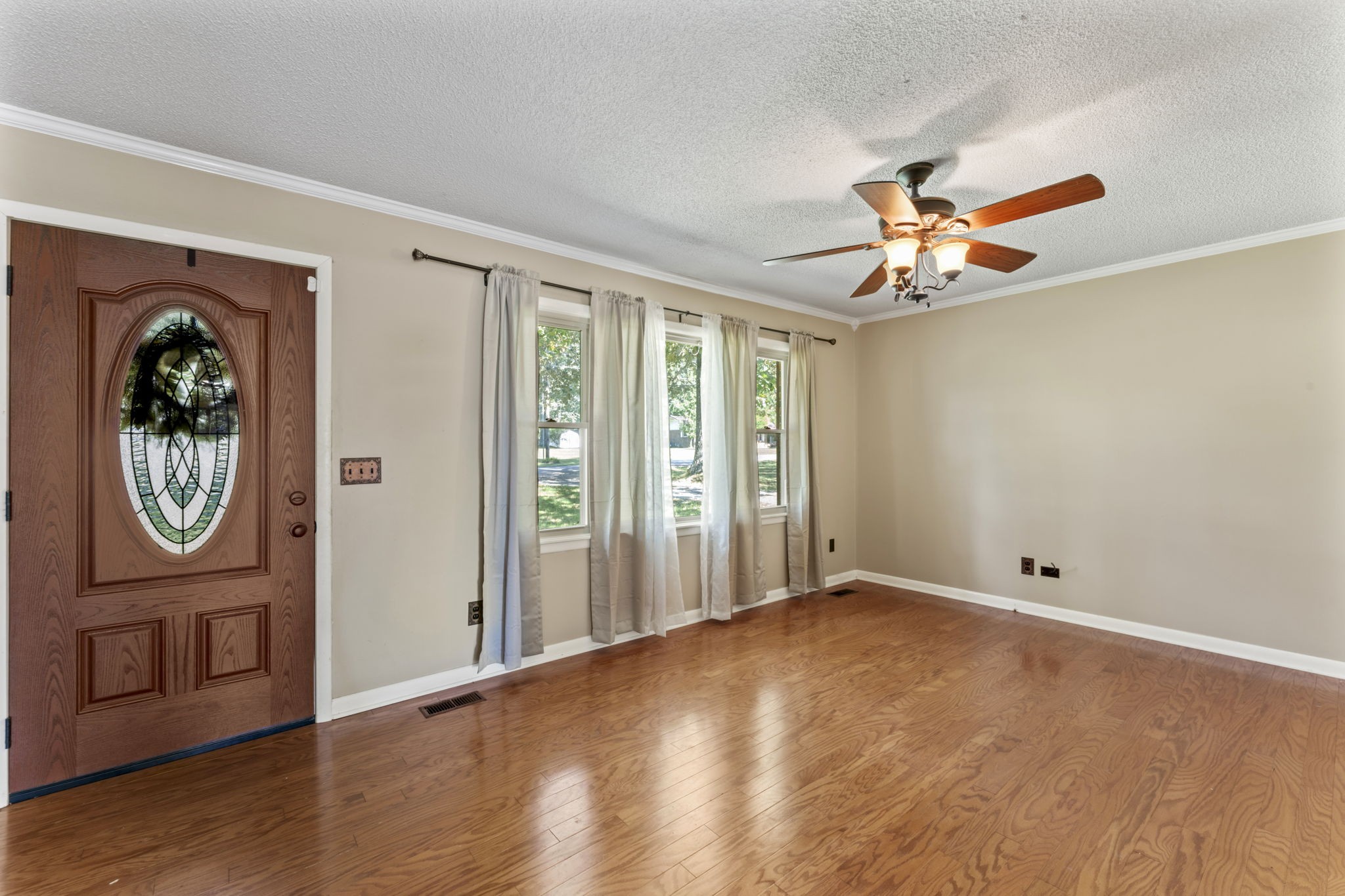 499 Ridgewood Drive Manchester, TN 37355 - Photo 8 of 37 a view of an empty room with a window and wooden floor