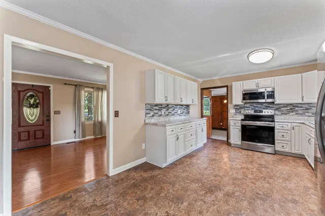 a kitchen with stainless steel appliances a stove top oven