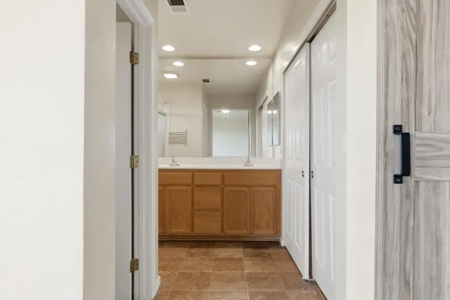 a bathroom with a glass shower door and a sink