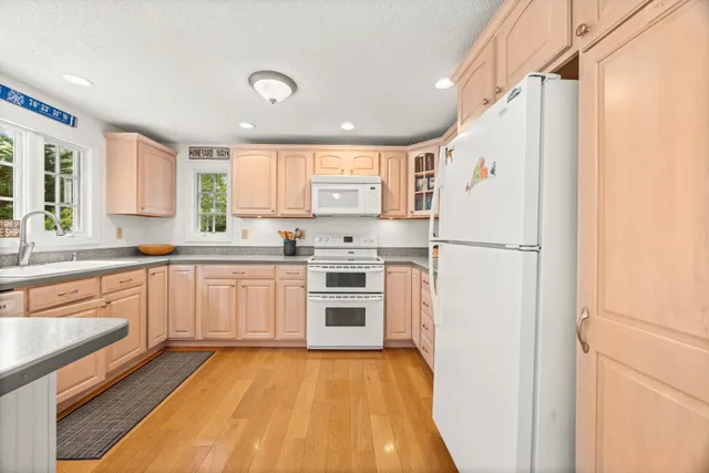 a kitchen with a refrigerator a sink and cabinets