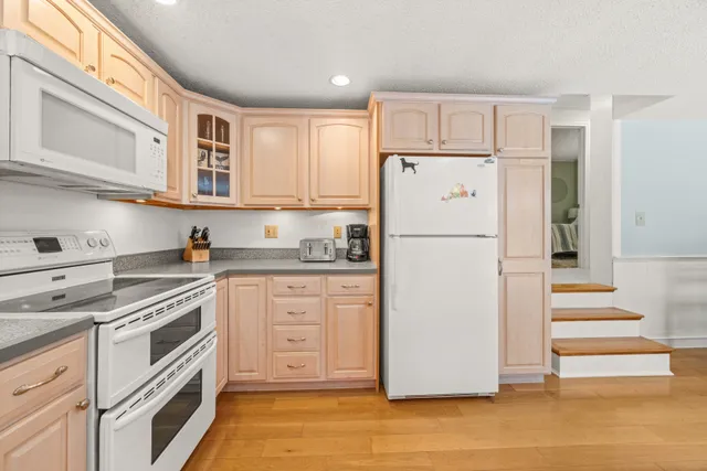 a white refrigerator freezer and a stove in a kitchen