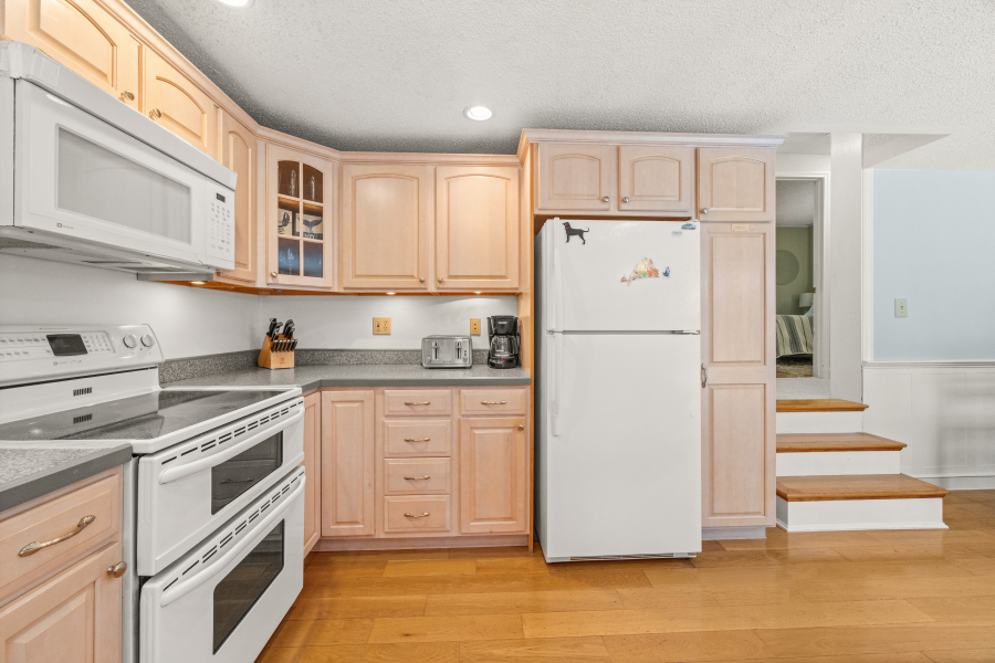 112 3rd Street North Edgartown, MA 02539 - Photo 12 of 36 a white refrigerator freezer and a stove in a kitchen