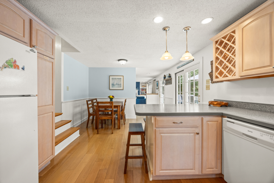 112 3rd Street North Edgartown, MA 02539 - Photo 14 of 36 a kitchen with granite countertop white cabinets and refrigerator