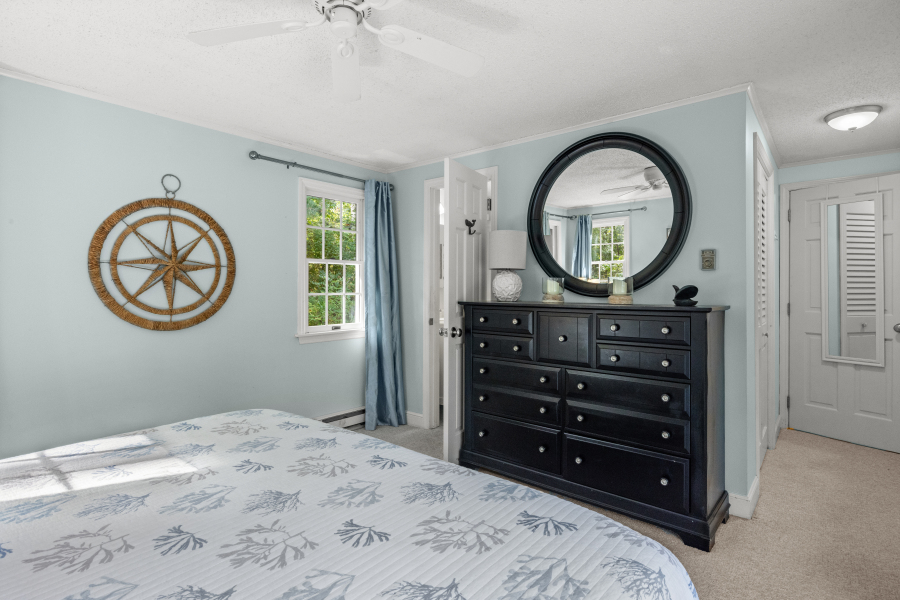 112 3rd Street North Edgartown, MA 02539 - Photo 18 of 36 a bedroom with a bed and a mirror on dresser