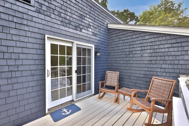 a wooden bench sitting in front of a building