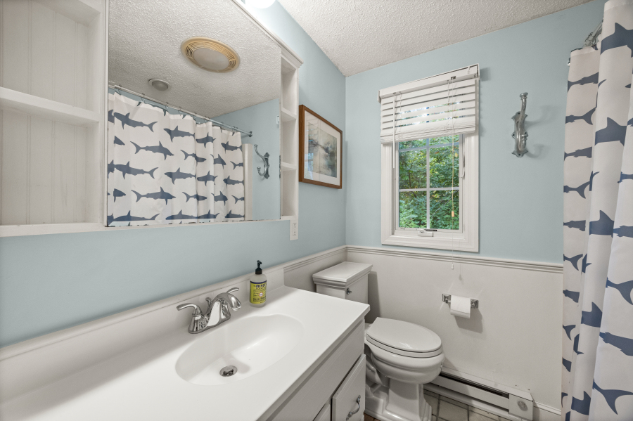 112 3rd Street North Edgartown, MA 02539 - Photo 28 of 36 a bathroom with a sink a toilet and a mirror