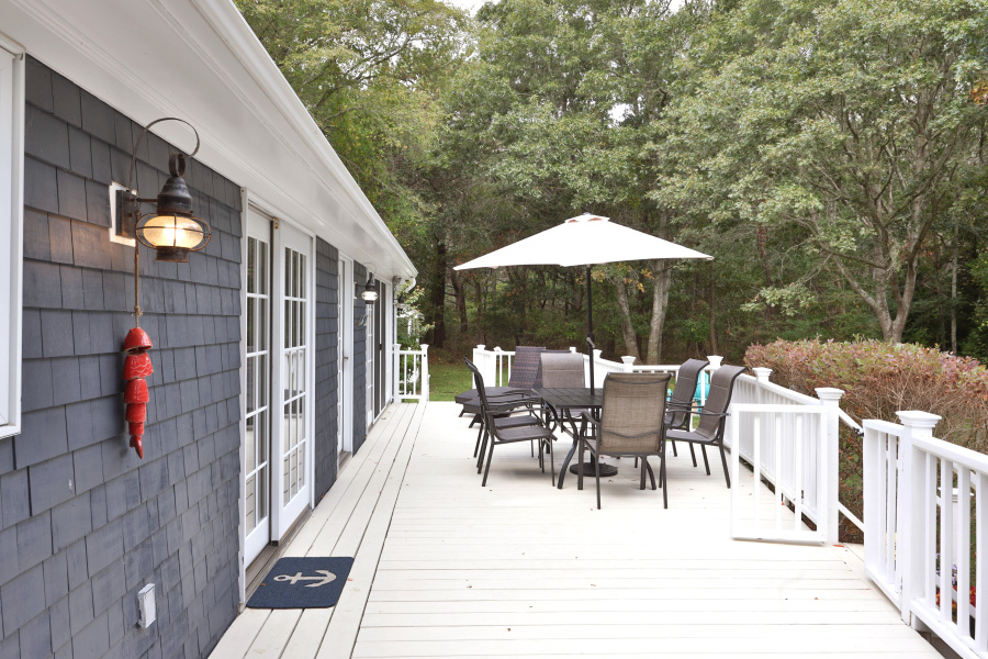 112 3rd Street North Edgartown, MA 02539 - Photo 29 of 36 a view of a patio with dining table and chairs under an umbrella