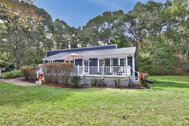 a view of a house with a yard and sitting area