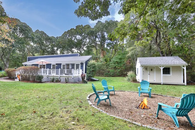 a view of a house with a yard and a patio