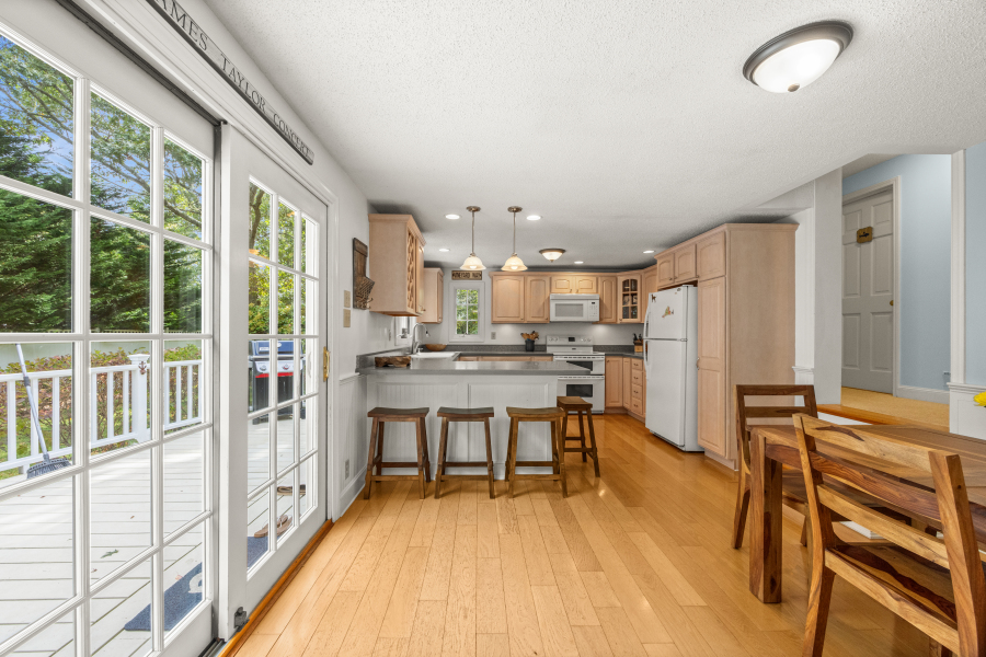 112 3rd Street North Edgartown, MA 02539 - Photo 8 of 36 a view of a kitchen with dining table and chairs