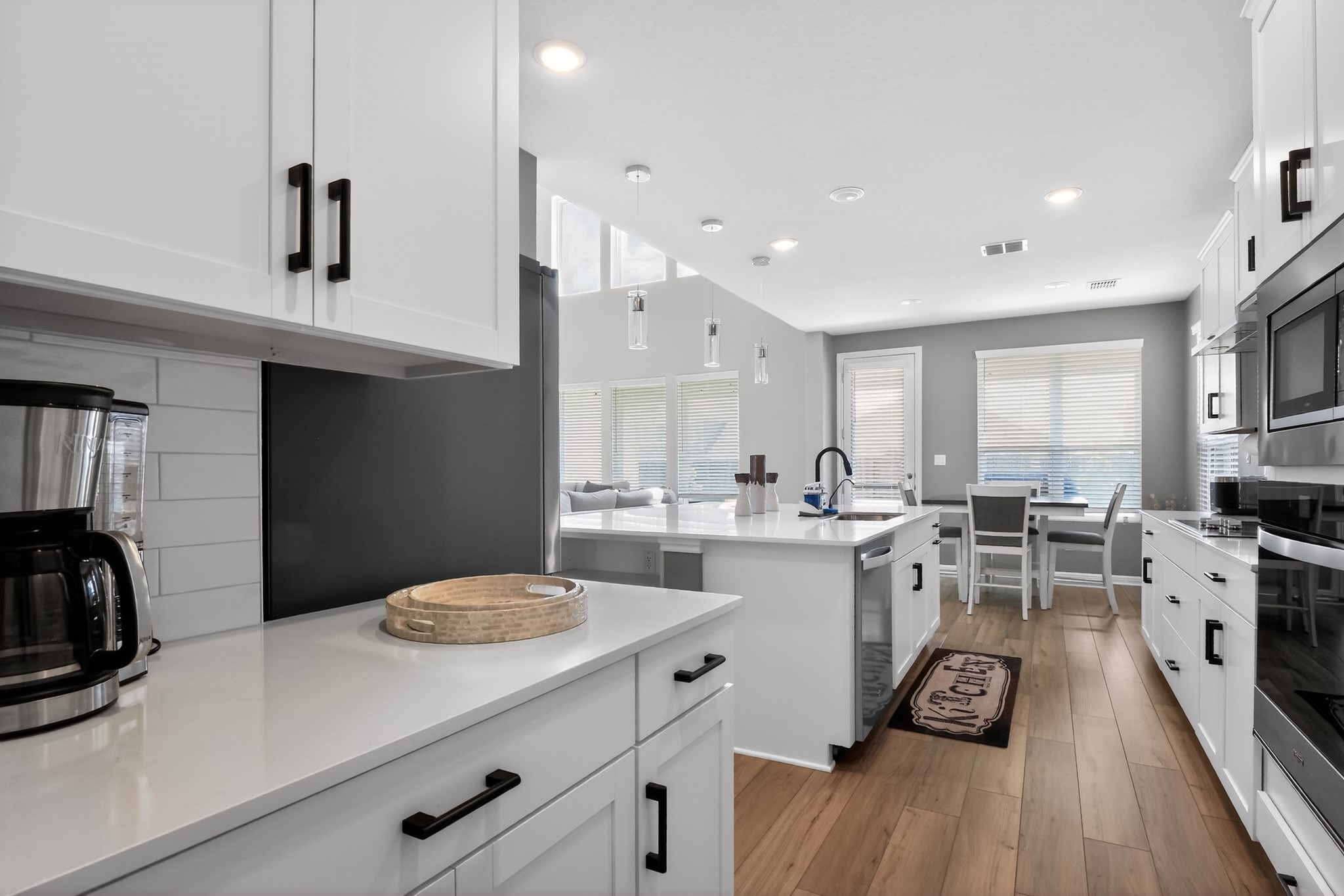 114 Bosco Road Hutto, TX 78634 - Photo 8 of 39 Modern kitchen with sleek white cabinetry and an inviting open-concept layout.