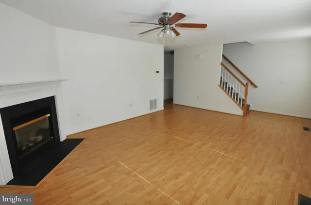a view of an empty room with a fireplace