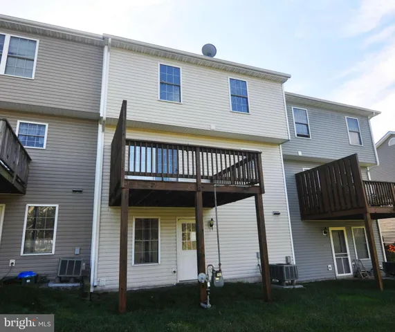 a front view of a house with a garden and deck