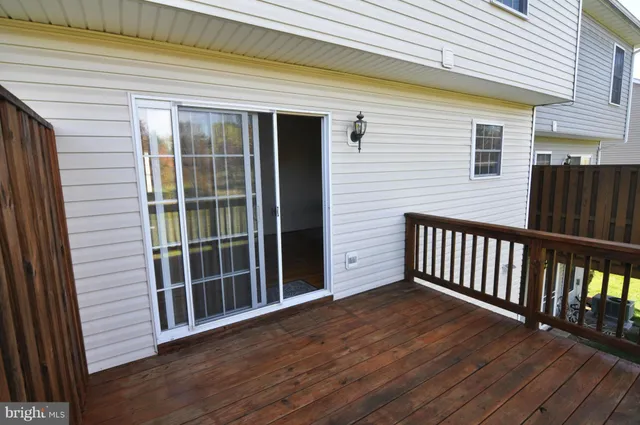 a view of backyard with deck and wooden floor