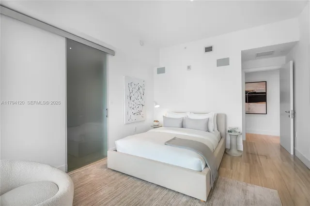 a bedroom with a bed and a couch