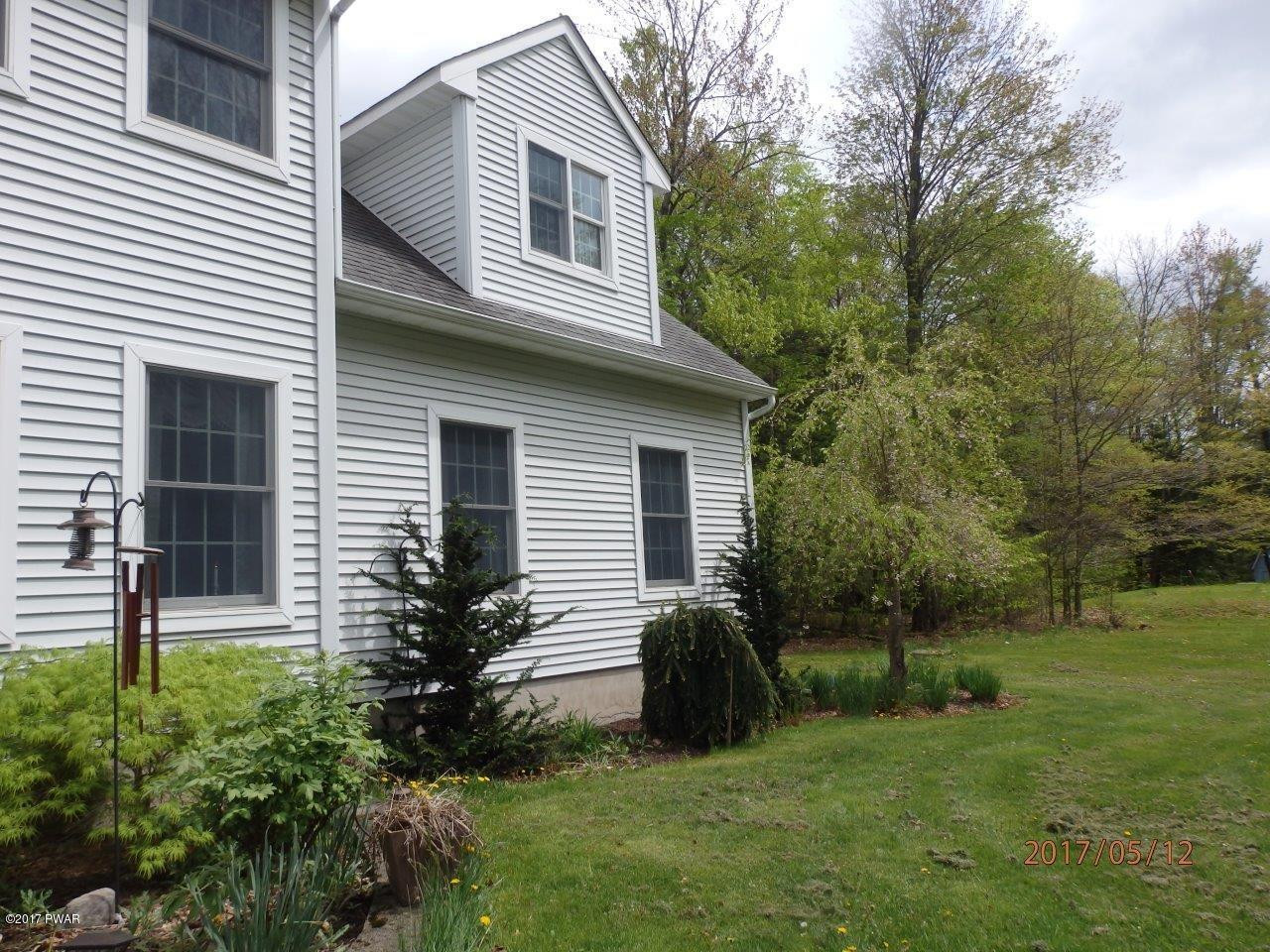 271 Sawmill Road Greentown, PA 18426 - Photo 25 of 36 a backyard of a house with plants and large tree