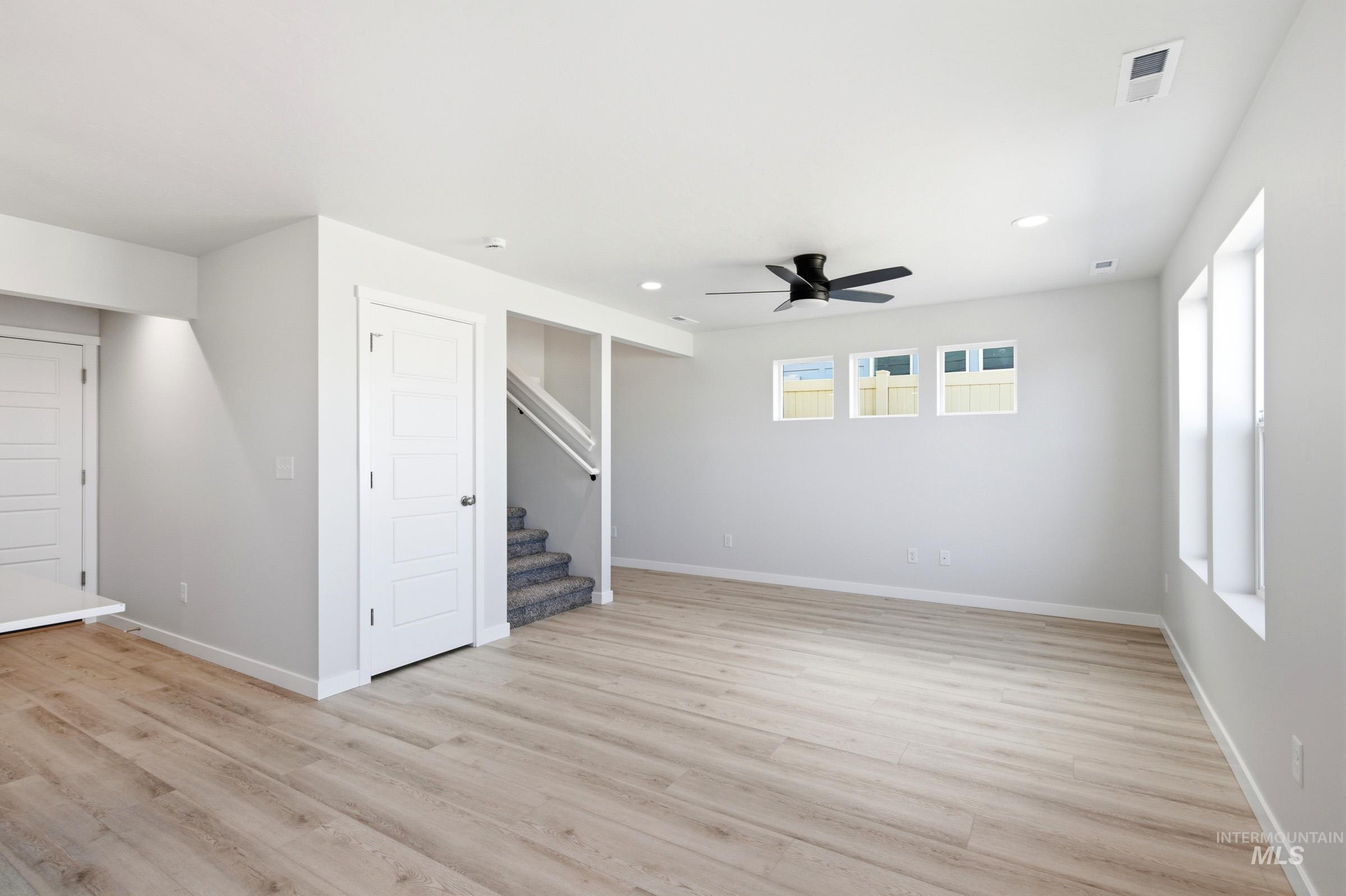 10812 Rutland Street Caldwell, ID 83605 - Photo 6 of 21 Spacious room featuring light wood-finish flooring, recessed lighting, and a modern ceiling fan