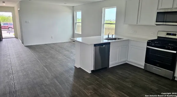 a kitchen with wooden floors and a stove