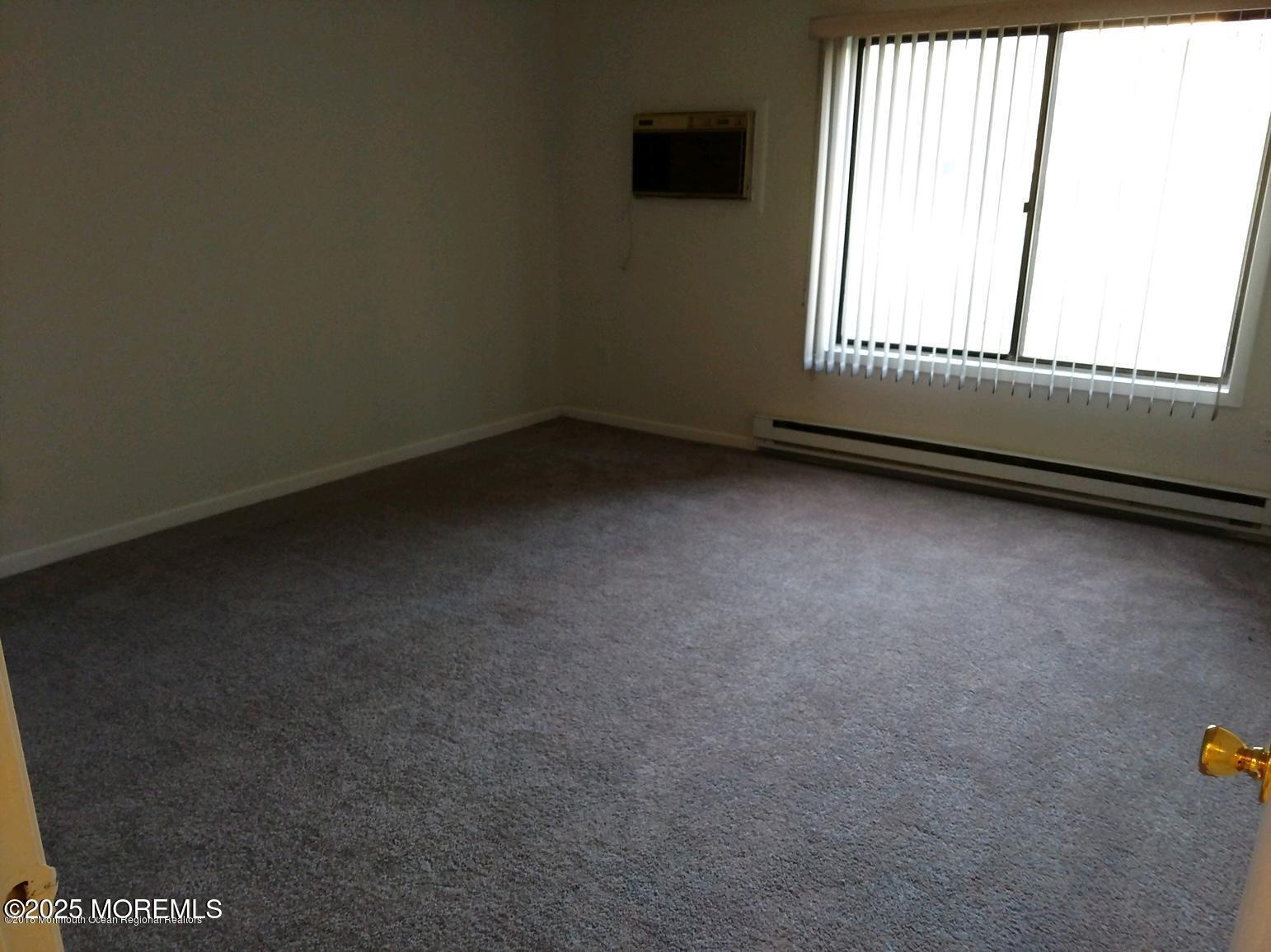 137 Amberly Drive, Unit E Manalapan, NJ 07726 - Photo 20 of 24 an empty room with a window