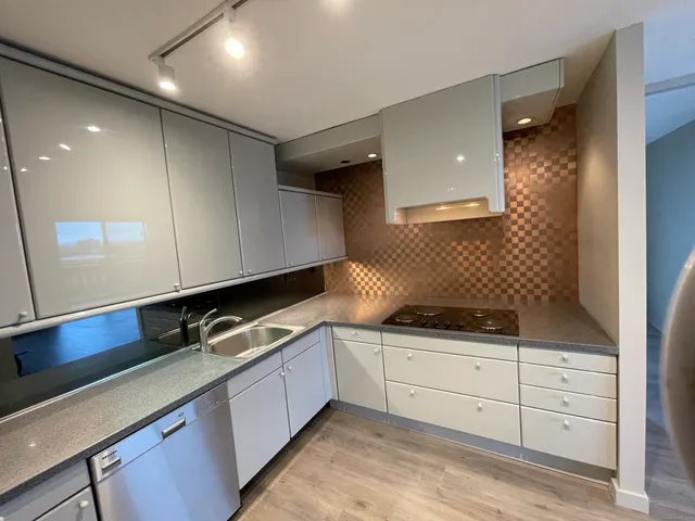 a kitchen with granite countertop a sink and cabinets