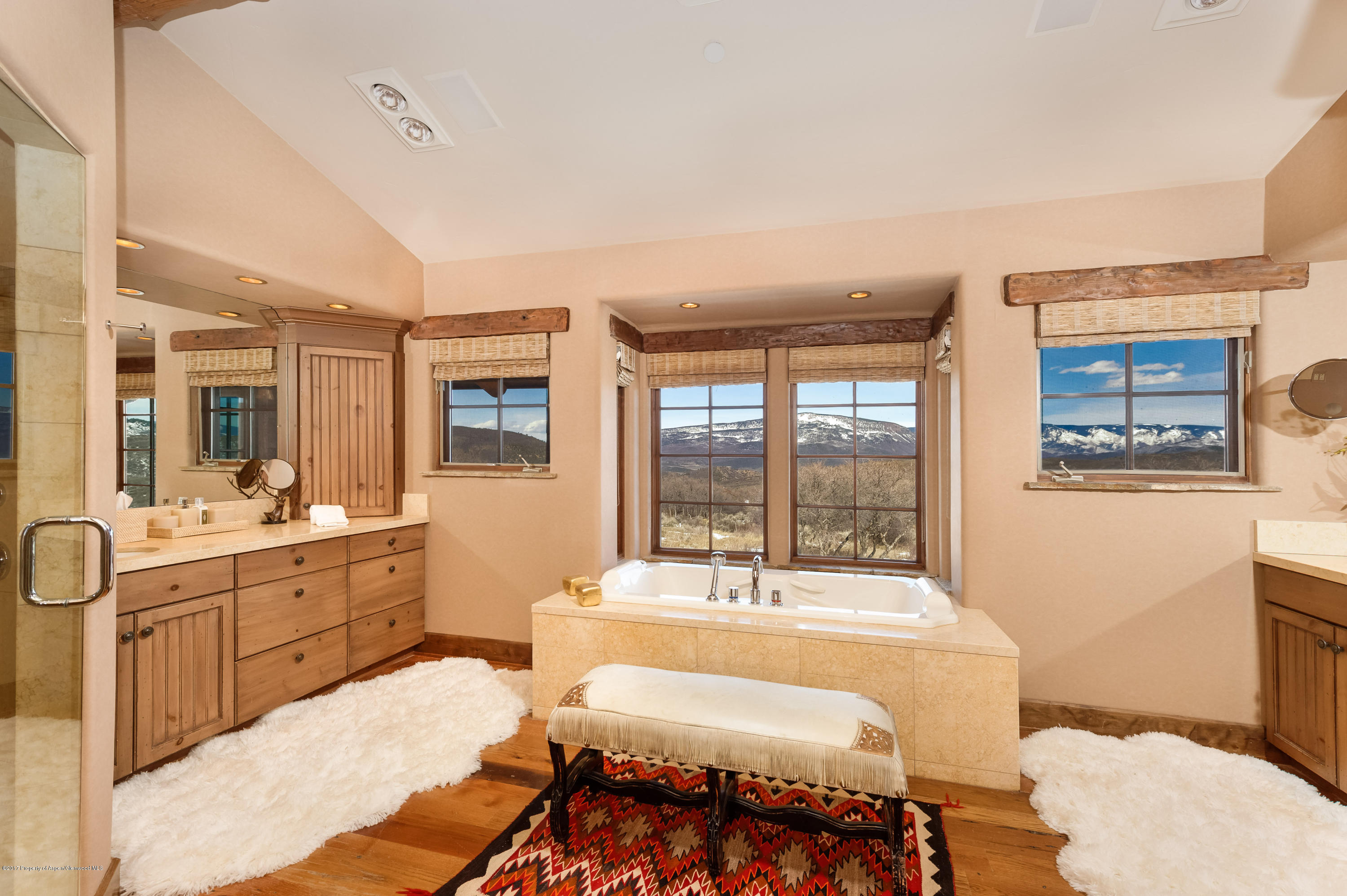227 Sage Rim Circle Basalt, CO 81621 - Photo 26 of 42 a spacious bathroom with a double vanity sink a mirror and a bathtub