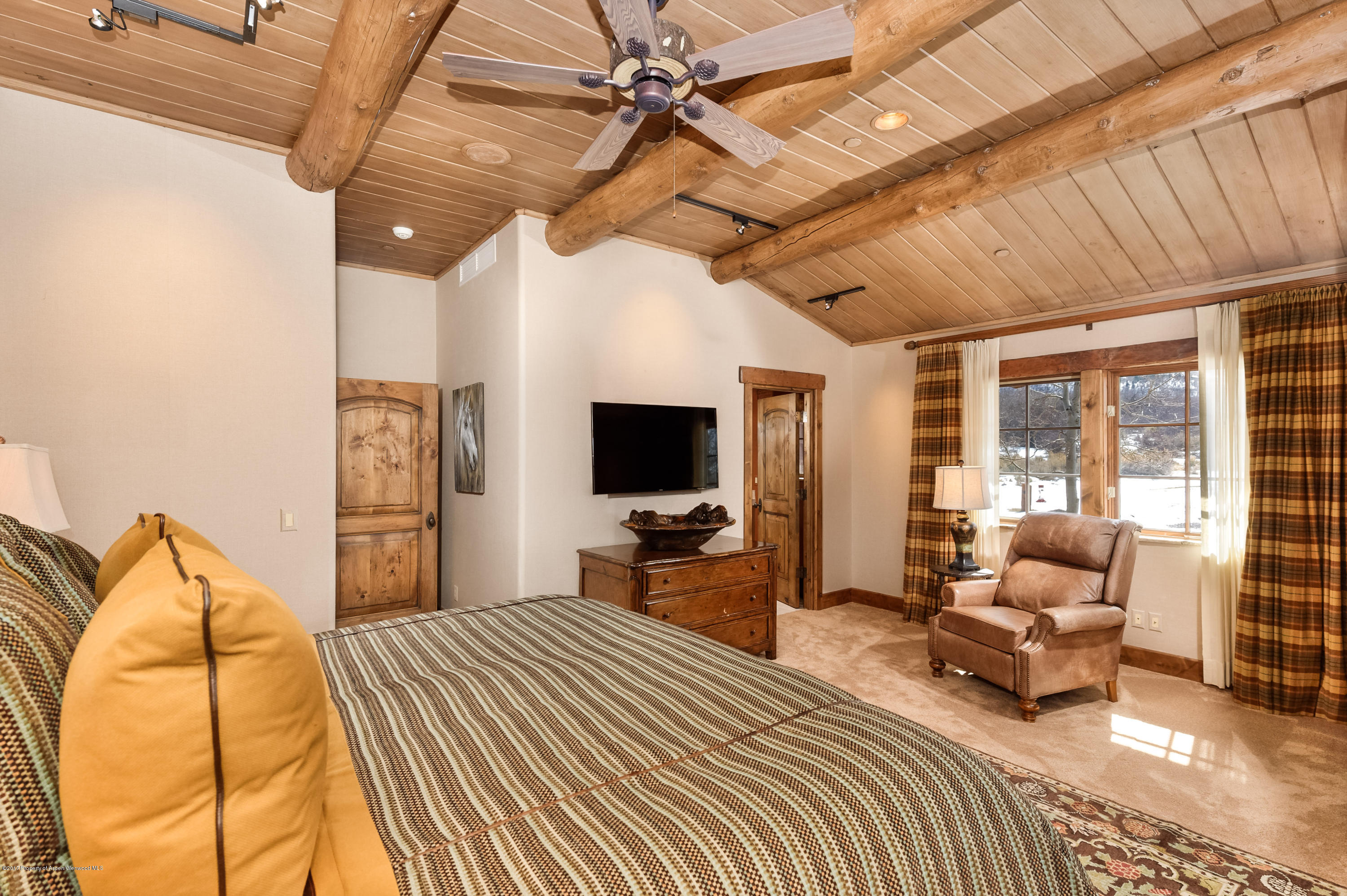 227 Sage Rim Circle Basalt, CO 81621 - Photo 27 of 42 a bedroom with a bed and wooden floor
