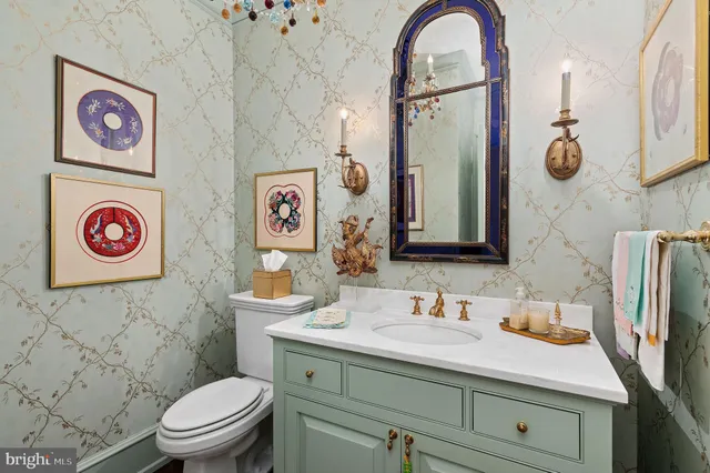 a bathroom with a sink a toilet and a mirror