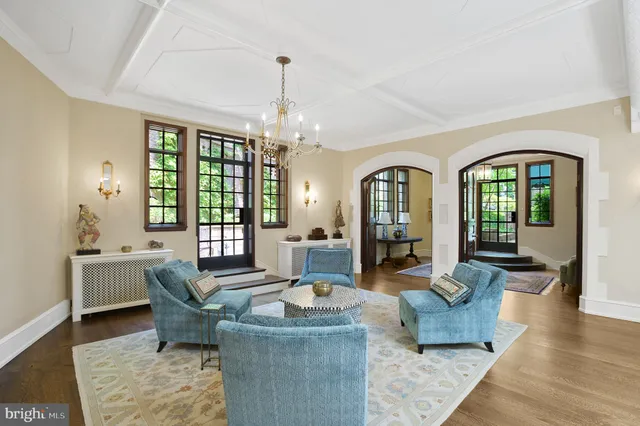 a living room with furniture and a chandelier