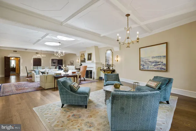 a living room with furniture and a chandelier