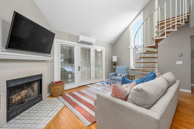 a living room with furniture fireplace and flat screen tv