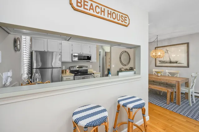 a kitchen with stainless steel appliances granite countertop a refrigerator and microwave