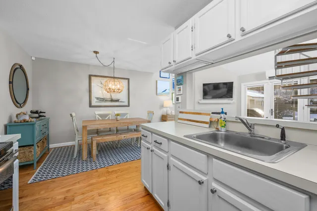 a kitchen with stainless steel appliances granite countertop a sink a stove counter space and cabinets